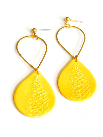 Yellow drop with foliage and brass