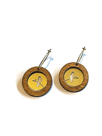 Wood with brass birds in circles